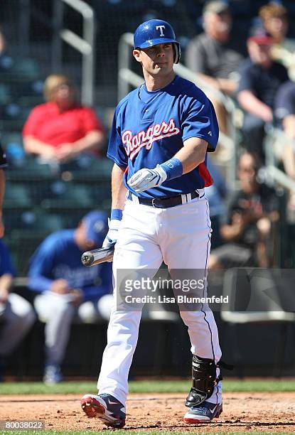 Michael Young of the Texas Rangers walks back to the dugout during the game against the Kansas City Royals during a preseason game at Surprise...