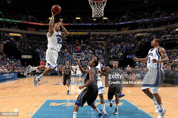 Derrick Rose of the Memphis Tigers drives to the basket for a dunk against Rod Earls of the Tulsa Golden Hurricane at FedExForum on February 27, 2008...
