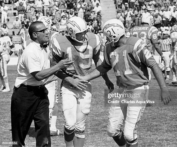 San Diego Chargers head coach Sid Gillman congratulates flanker Lance Alworth and quarterback John Hadl following a 31-14 victory over the Houston...