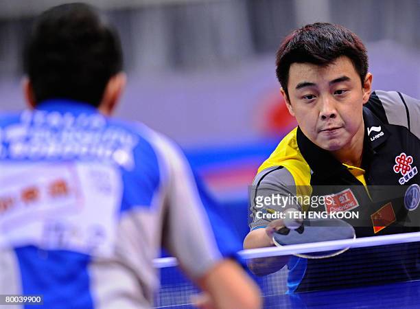 China's Wang Hao returns a shot against Italy's Mihai Bobocica during the men's last round of 16 at the World Team Table Tennis Championships in...