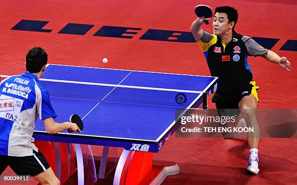 China's Wang Hao returns a shot against Italy's Mihai Bobocica during the men's last round of 16 at the World Team Table Tennis Championships in...