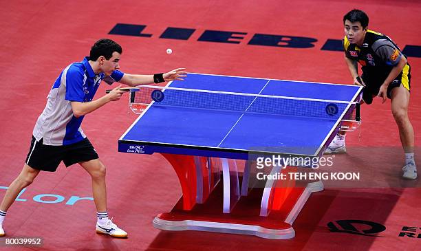Italy's Mihai Bobocica serves against China's Wang Hao during the men's last round of 16 at the World Team Table Tennis Championships in Guangzhou,...
