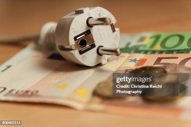 multiple socket and euro banknotes on white background, close-up - steckerleiste stock-fotos und bilder