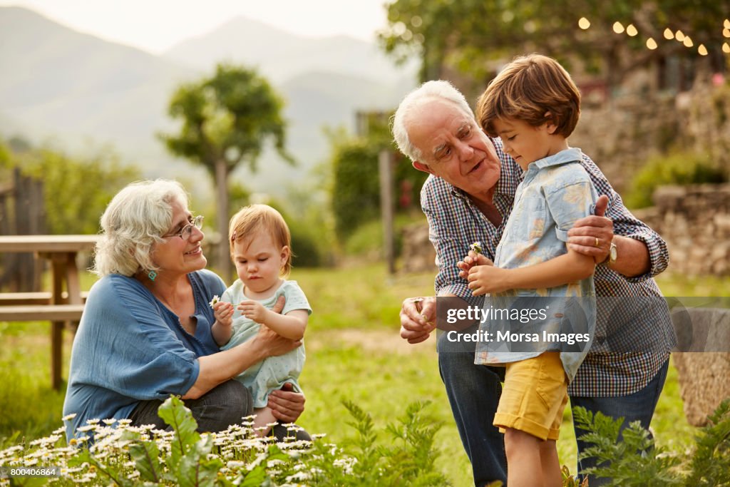 Hablando a los niños en la yarda de abuelos