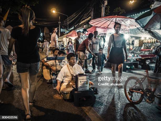 blind musicians playing at the sunday street night market chiang mai thailand - chiang mai sunday market stock pictures, royalty-free photos & images