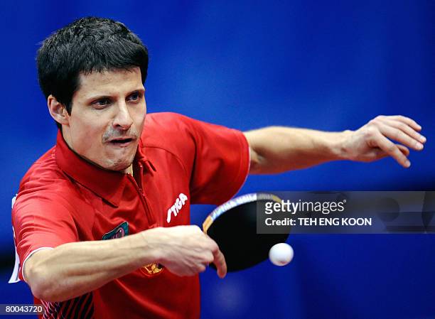 Russia's Alexei Smirnov returns a shot against Romania's Andrei Filimon during the men's quarter final round of the World Team Table Tennis...