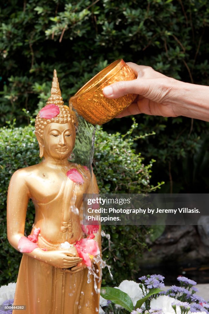 Buddha Bathing Ceremony during Songkran in Wat Pho, Bangkok, Thailand