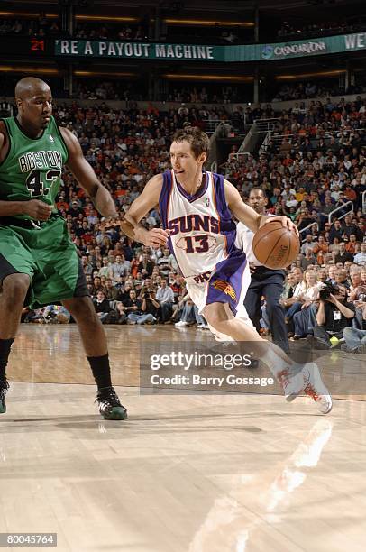 Steve Nash of the Phoenix Suns drives to the basket against Kendrick Perkins of the Boston Celtics during the game at U.S. Airways Center on February...