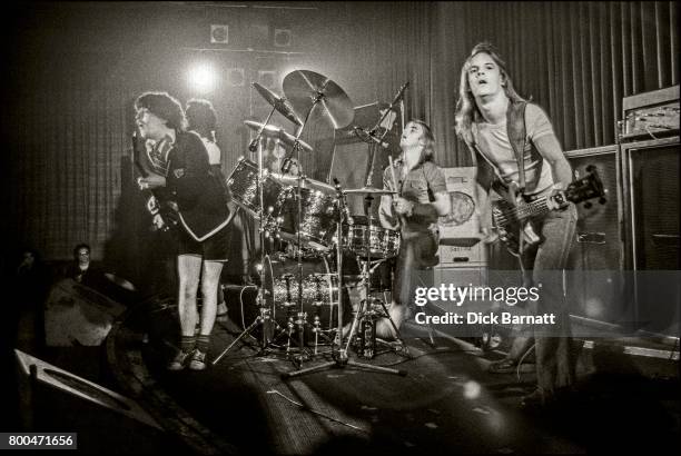 Angus Young and Mark Evans of AC/DC performing on stage, Nashville Rooms, London, 27th May 1976.