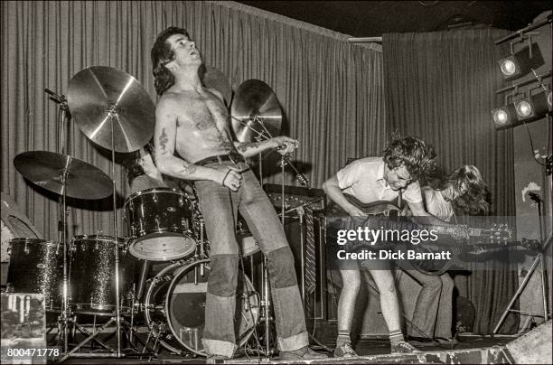 Bon Scott, Angus Young and Mark Evans of AC/DC performing on stage, Nashville Rooms, London on May 27, 1976.