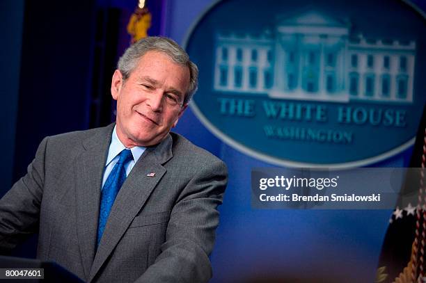 President George W. Bush laughs during a press conference at the White House February 28, 2008 in Washington, DC. President Bush spoke about FISA...