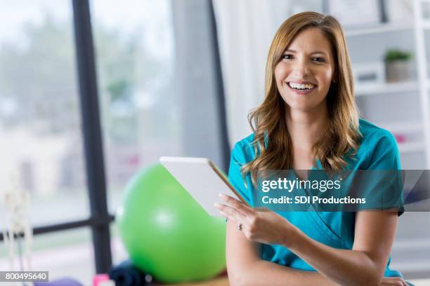 portrait of beautiful physical therapist - physical therapist stock pictures, royalty-free photos & images