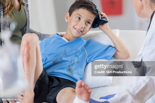 injured male soccer player holds ice pack on his head - head injury stock pictures, royalty-free photos & images