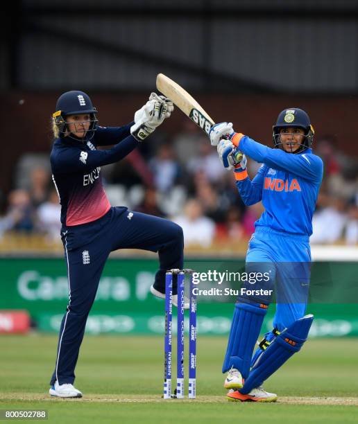 India batsman Smrti Mandhana hits a six watched by Sarah Taylor during the ICC Women's World Cup 2017 match between England and India at The 3aaa...