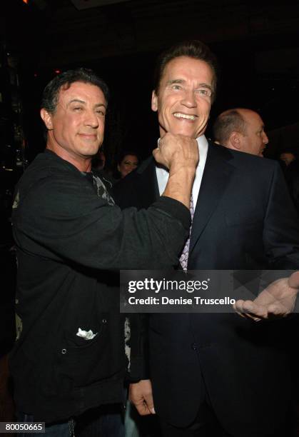 Actor Sylvester Stallone and California governor Arnold Schwarzenegger pose for photos at the pre-red carpet cocktail party for the world premiere of...