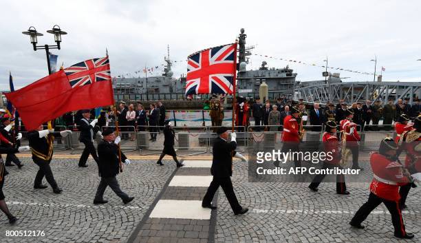 Britain's Prince Edward, Earl of Wessex and Britain's Prime Minister Theresa May watch a parade of military personnel in front of the Royal Navys...