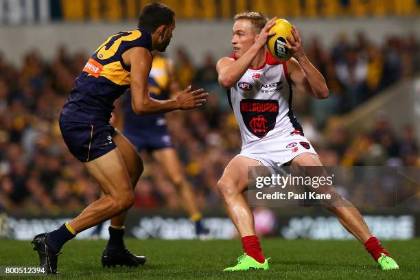 Bernie Vince of the Demons looks to take on Josh Hill of the Eagles during the round 14 AFL match between the West Coast Eagles and the Melbourne...