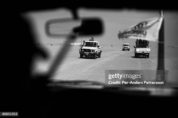 Armed security patrols escort aid worker vehicles outside the Oure Cassoni refugee camp on July 26, 2007 about 23 kilometers outside Bahai, Chad. Aid...