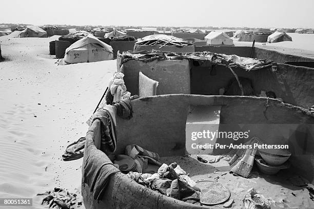 Mud and canvas homes stand damaged after a sandstorm in the Oure Cassoni refugee camp on July 26, 2007 about 23 kilometers outside Bahai, Chad. Since...