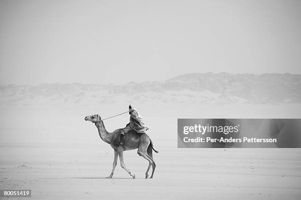 Man rides a camel in the desert near the border of Darfur close to the Oure Cassoni refugee camp on July 26, 2007 about 23 kilometers outside Bahai,...