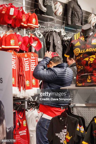 British & Irish Lions fan tries on merchadise before the Rugby Test match between the New Zealand All Blacks and the British & Irish Lions on June...
