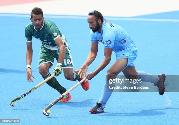 Ammad Shakeel of Pakistan and Sardar Singh of India battle for possession during the 5th-8th place match between Pakistan and India on day eight of...