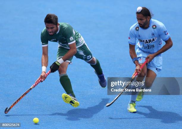 Abu Mahmood of Pakistan and Akashdeep Singh of India battle for possession during the 5th-8th place match between Pakistan and India on day eight of...