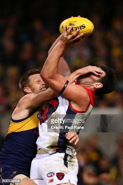 Cameron Pedersen of the Demons marks the ball against Sam Mitchell of the Eagles during the round 14 AFL match between the West Coast Eagles and the...