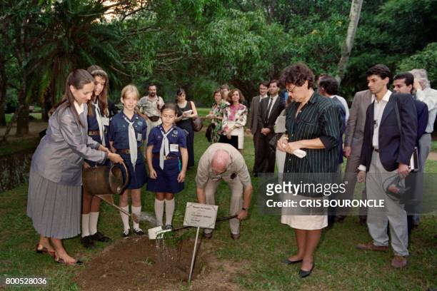 French Minister of the Environment and Way of Life Segolene Royal waters a small tree "Pau Brasil" on June 4, 1992 at the Botanical garden, during...