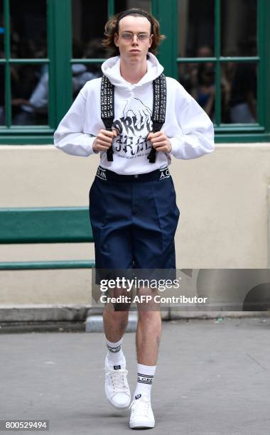 Model presents a creation by Andrea Crews house during men's Fashion Week for the Spring/Summer 2017/2018 collection in Paris on June 24, 2017. / AFP...