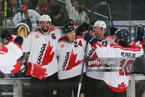Brett Ponich Adam Cracknell and Peter Holland of Canada celebrate winning the series after a sudden death goal by Adam Cracknell during the Ice...