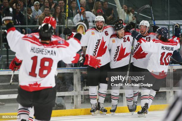 Canada players celebrate winning the series after a sudden death goal by Adam Cracknell during the Ice Hockey Classic match between the United States...