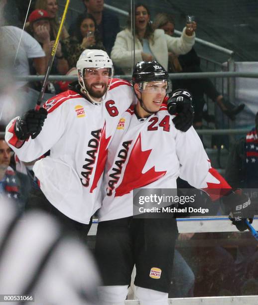 Brett Ponich and Adam Cracknell celebrate winning the series after a sudden death goal by Adam Cracknell during the Ice Hockey Classic match between...