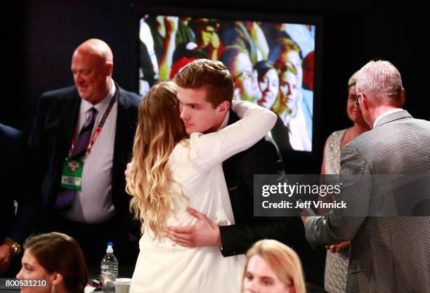 Michael Rasmussen, ninth overall pick of the Detroit Red Wings, celebrates with his family during Round One of the 2017 NHL Draft at United Center on...