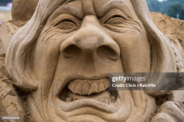 Sand sculpture of British Prime Minister Theresa May, which took two days to build, is seen in the Park area at Glastonbury Festival Site on June 24,...