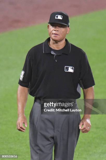 Umpire Kerwin Danley looks on during a baseball game between the Baltimore Orioles and the Cleveland Indians at Oriole park at Camden Yards on June...