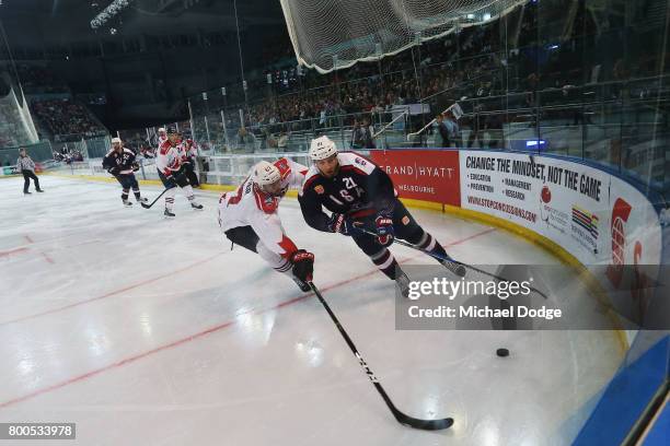 Terry Yake of Canada and Stefan Matteau of the USA compete for the puck during the Ice Hockey Classic match between the United States of America and...