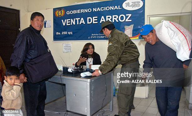 Bolivian policemen control the sale of imported rice at a govenment storehouse in La Paz, on February 28, 2008. Bolivian President Evo Morales issued...