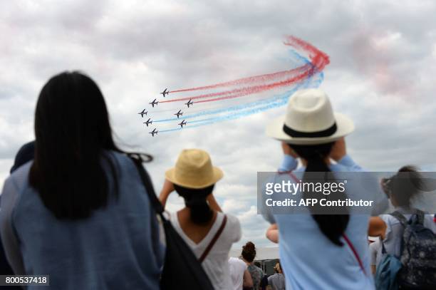 Spectators watch as France's Patrouille de France jets perform a flying display at Le Bourget airport, near Paris, on June 24, 2017 during the public...