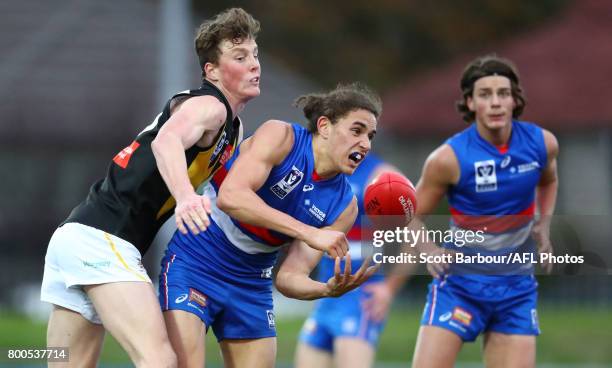 Tristan Tweedie of Footscray is tackled during the 2017 VFL round 10 match between the Footscray Bulldogs and the Werribee Tigers at Whitten Oval on...