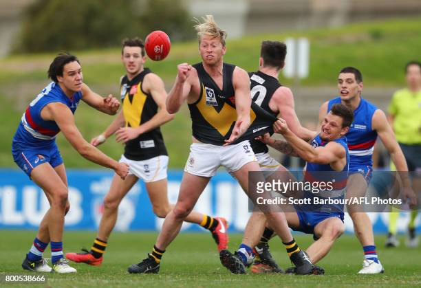 Jordan Jones of Werribee is tackled during the 2017 VFL round 10 match between the Footscray Bulldogs and the Werribee Tigers at Whitten Oval on June...