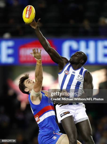 Majak Daw of the Kangaroos and Tom Campbell of the Bulldogs compete in a ruck contest during the 2017 AFL round 14 match between the Western Bulldogs...