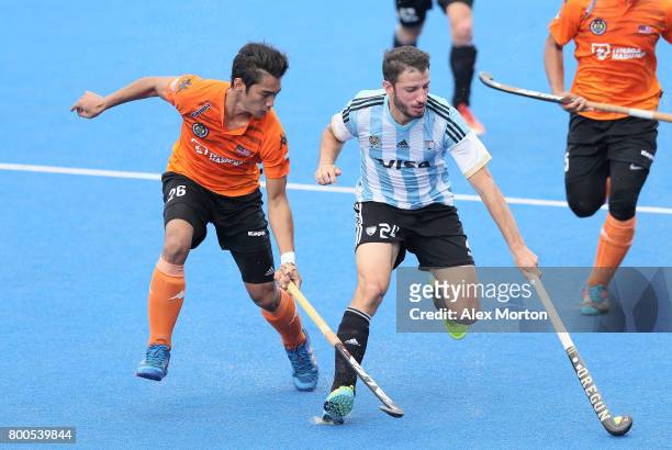 Sahril Saabah of Malaysia and Manuel Brunet of Argentina battle for possession during the semi-final match between Argentina and Malaysia on day...