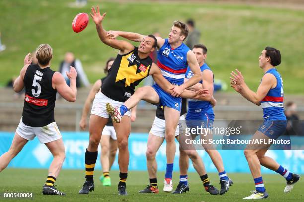 Jayden Foster of the Bulldogs and Braydon Preuss of Werribee compete for the ball during the 2017 VFL round 10 match between the Footscray Bulldogs...
