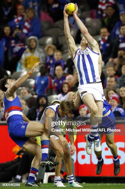 Tom Campbell of the Bulldogs, Mason Wood of the Kangaroos, Ben Brown of the Kangaroos and Dale Morris of the Bulldogs compete for the ball during the...