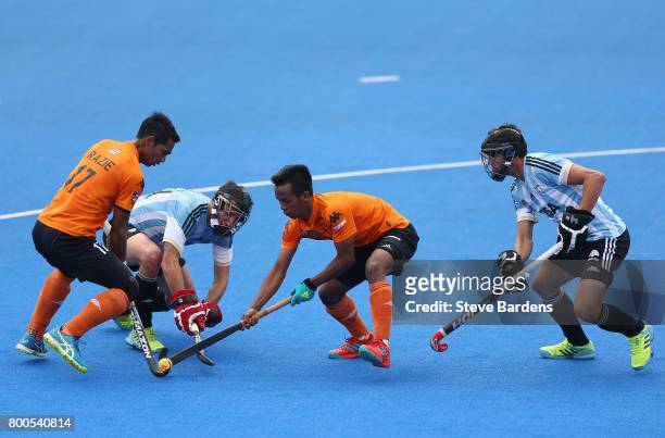 Razie Rahim of Malaysia and Faizal Saari of Malaysia battle for possession with Manuel Brunet of Argentina and Lucas Rey of Argentina during the...