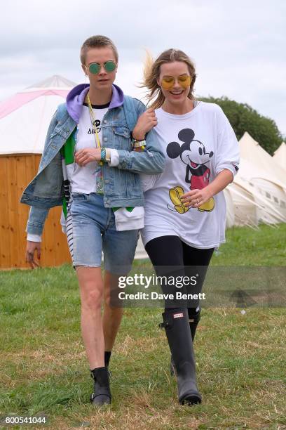 Cara Delevingne and Margot Robbie attend day two of Glastonbury on June 24, 2017 in Glastonbury, England.