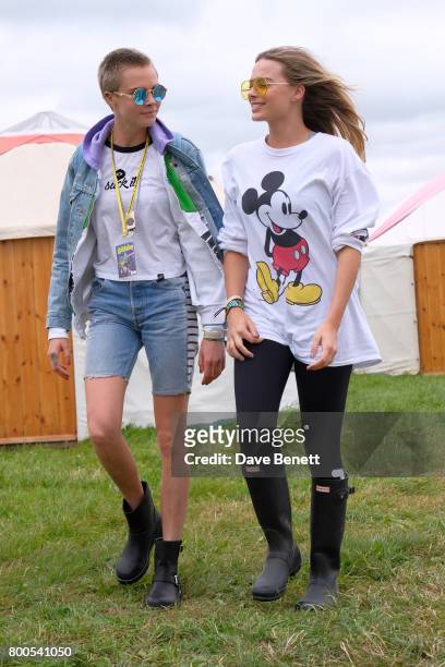 Cara Delevingne and Margot Robbie attend day two of Glastonbury on June 24, 2017 in Glastonbury, England.