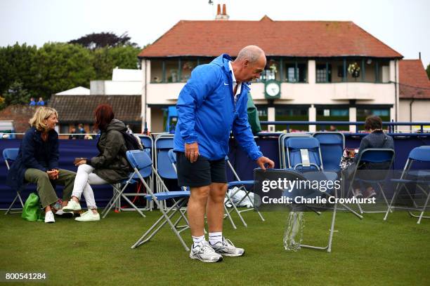 Marshall's clear water from spectator chairs after a long rain delay during Qualifying on Day 2 of The Aegon International Eastbourne on June 22,...