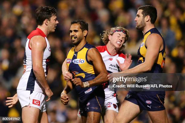 Jayden Hunt of the Demons strikes Lewis Jetta of the Eagles during the round 14 AFL match between the West Coast Eagles and the Melbourne Demons at...